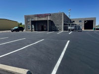 a parking lot with a building in the background